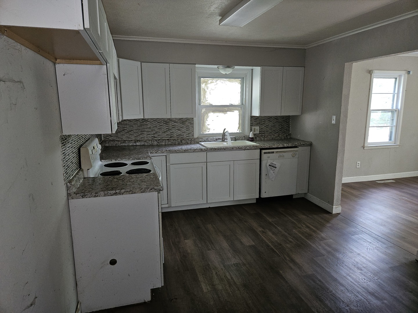 621 North 7th Street Herrin, IL 62948 - Photo 8 of 19 a kitchen with granite countertop a sink and a stove top oven