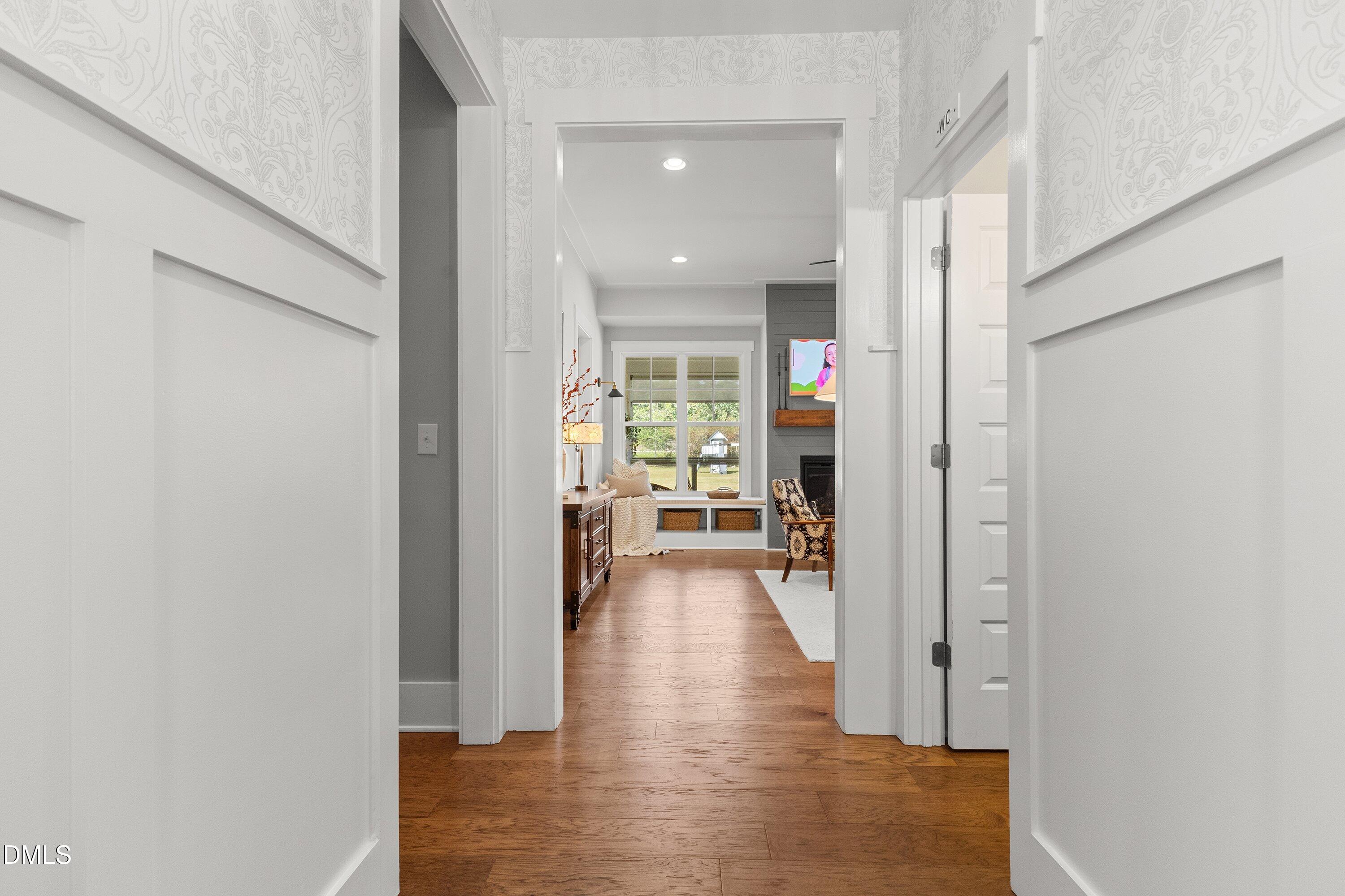 248 Old Hickory Drive Raleigh, NC 27603 - Photo 11 of 45 a view of a hallway with wooden floor and a living room