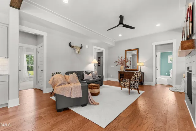 a living room with furniture and wooden floor