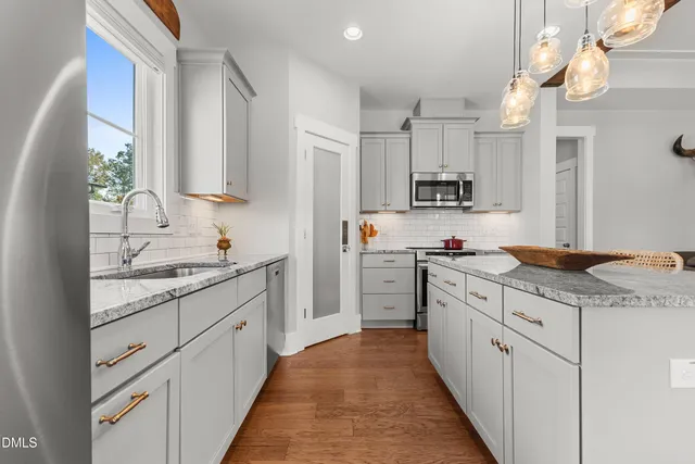 a spacious bathroom with a granite countertop sink a toilet and a mirror