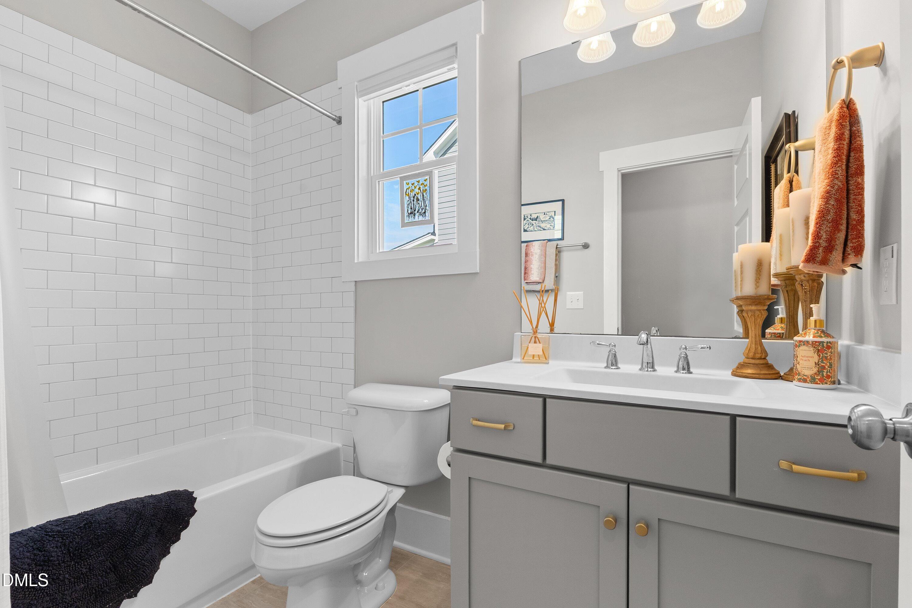 248 Old Hickory Drive Raleigh, NC 27603 - Photo 23 of 45 a bathroom with a toilet a sink and mirror