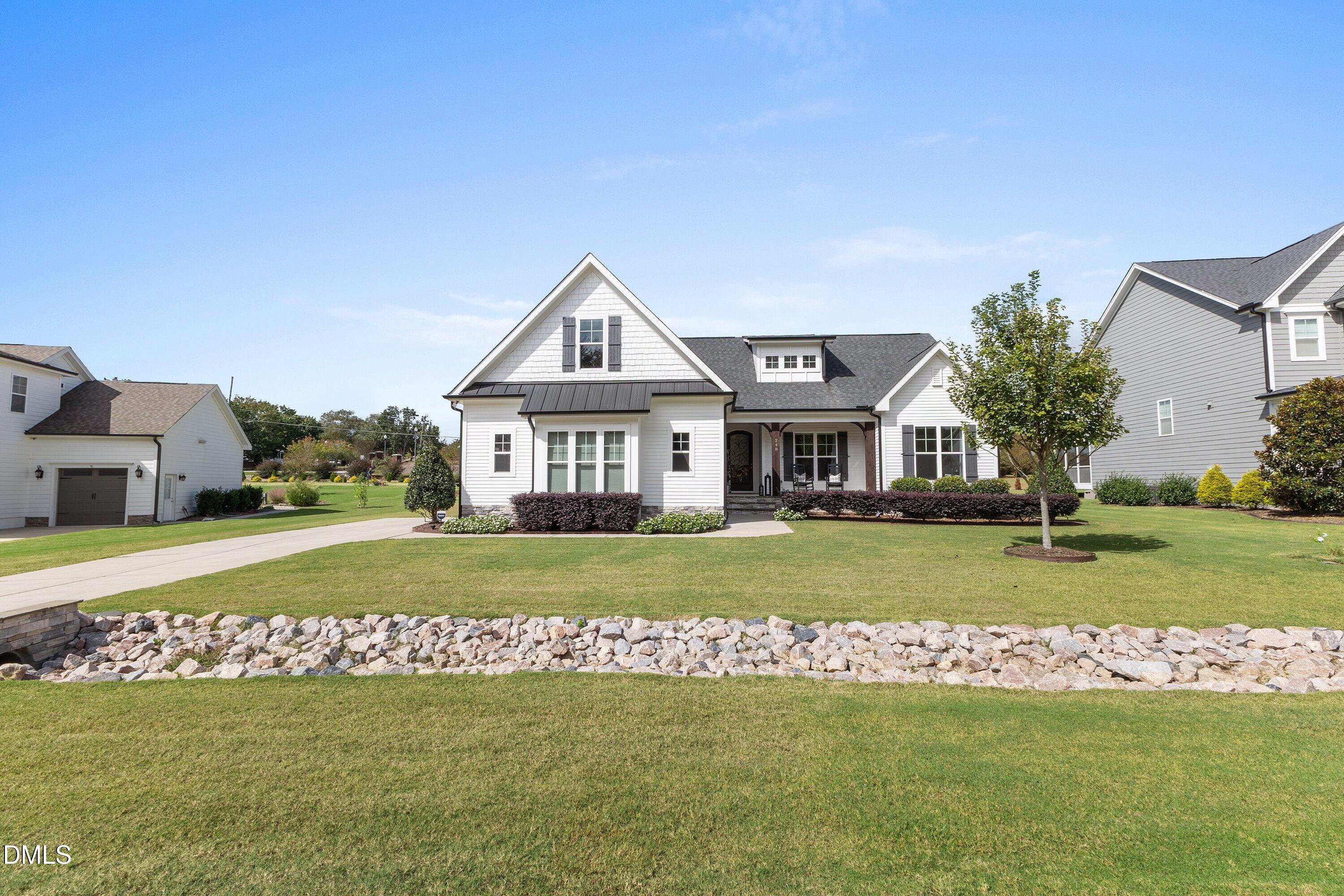 248 Old Hickory Drive Raleigh, NC 27603 - Photo 2 of 45 a front view of a house with a yard table and chairs