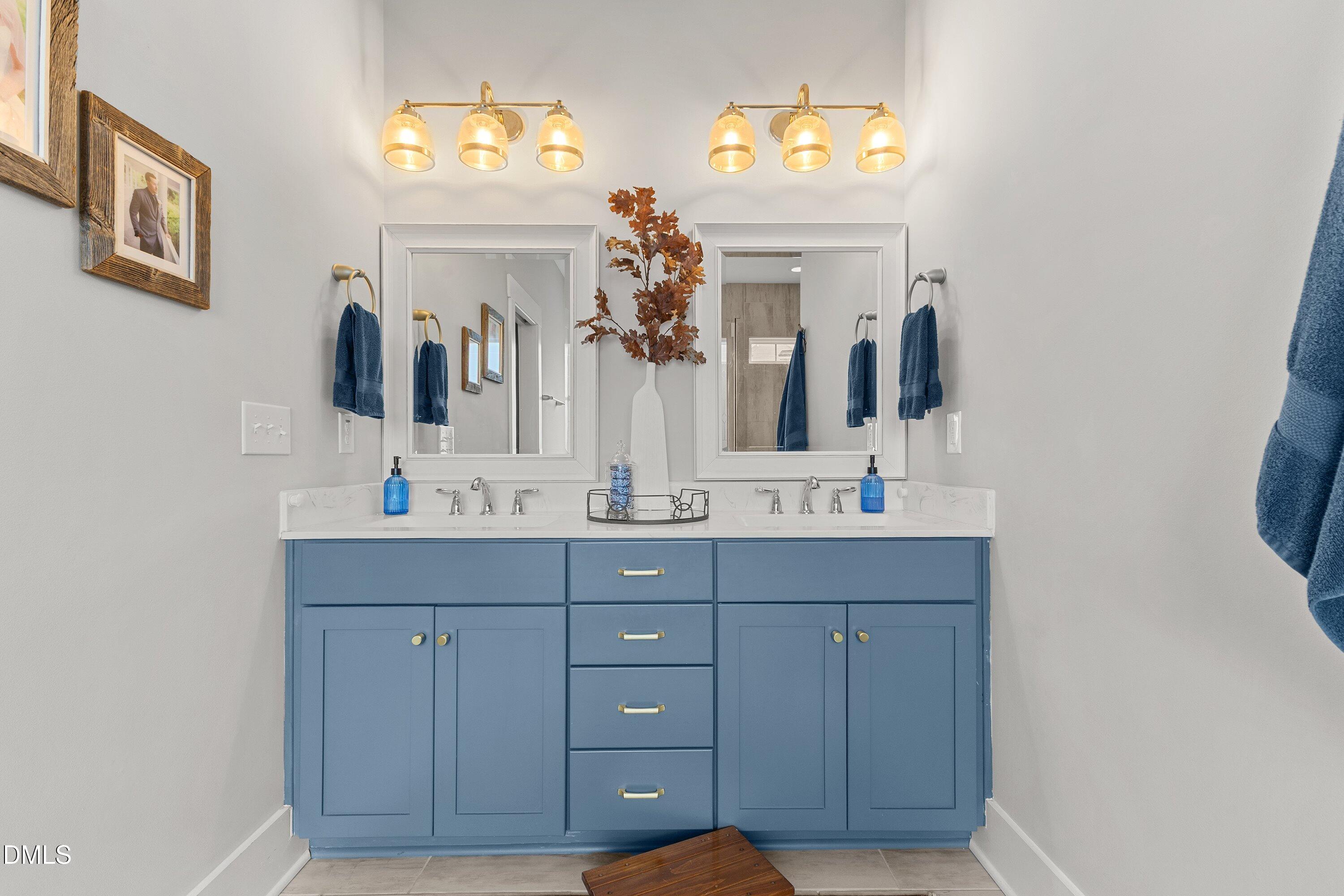 248 Old Hickory Drive Raleigh, NC 27603 - Photo 31 of 45 a bathroom with a double vanity sink and a mirror