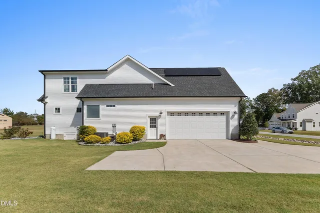 a front view of a house with a yard table and chairs