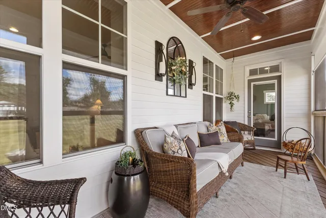 a living room with furniture and floor to ceiling windows