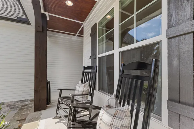 a view of a patio with a table chairs and a yard