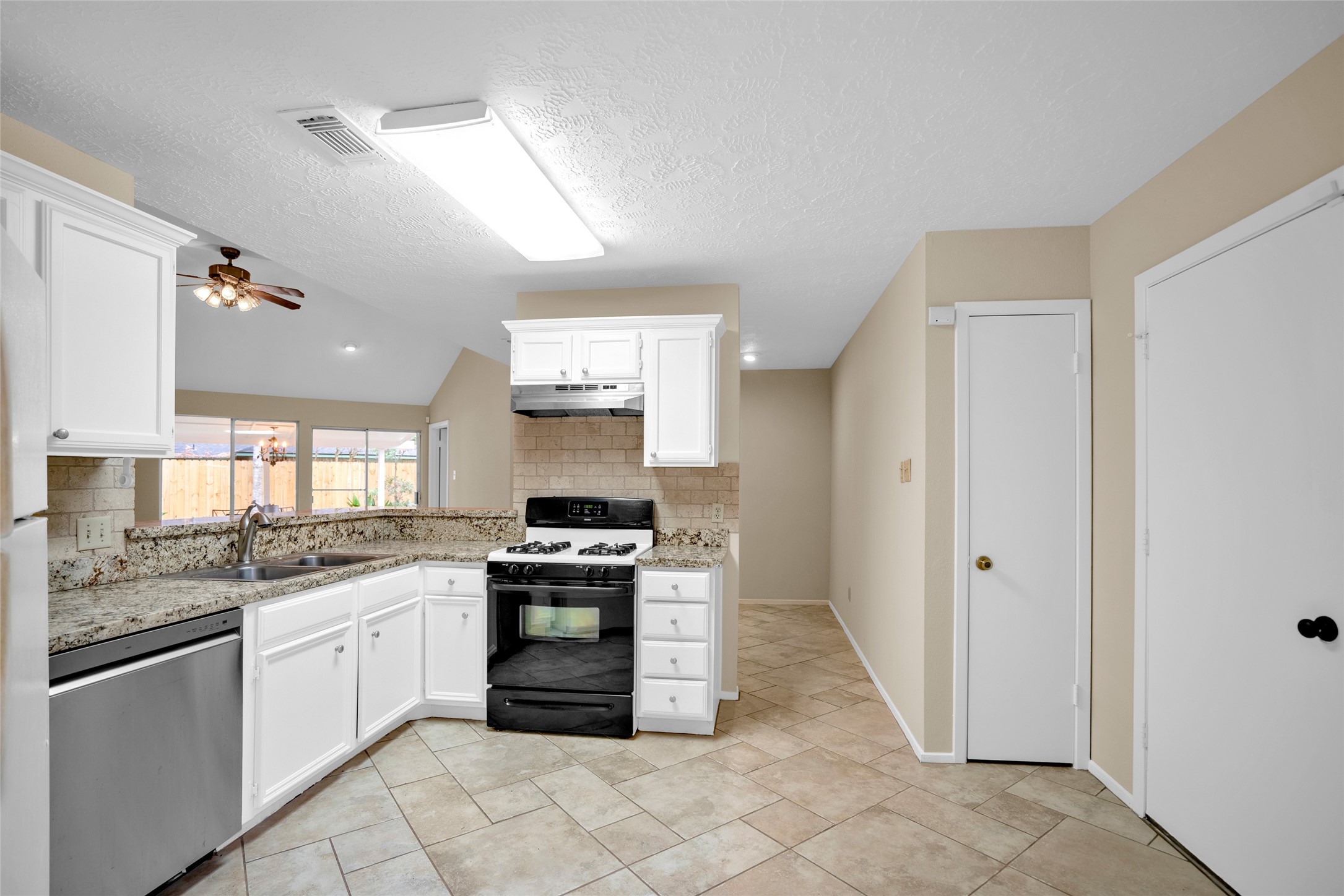 17323 Northchapel Street Spring, TX 77379 - Photo 15 of 37 Well-laid-out kitchen with generous counter space, pantry access, and open sightlines to living areas.