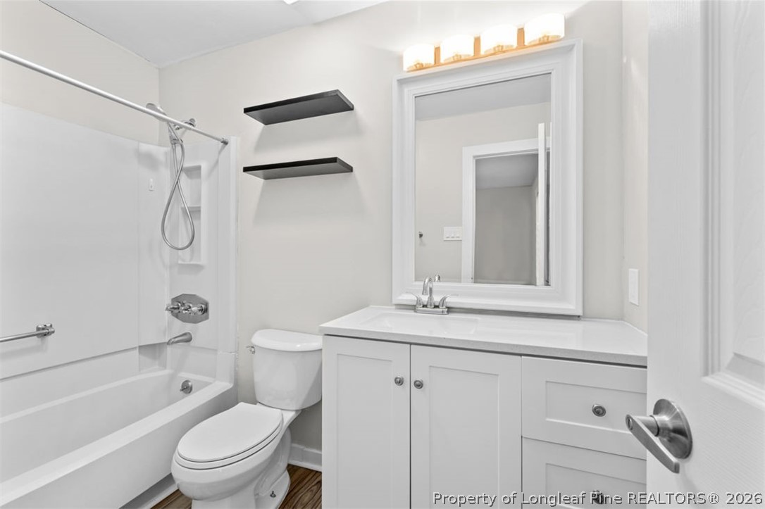 3305 Hunting Bay Drive Spring Lake, NC 28390 - Photo 18 of 27 a bathroom with a granite countertop sink a toilet and shower