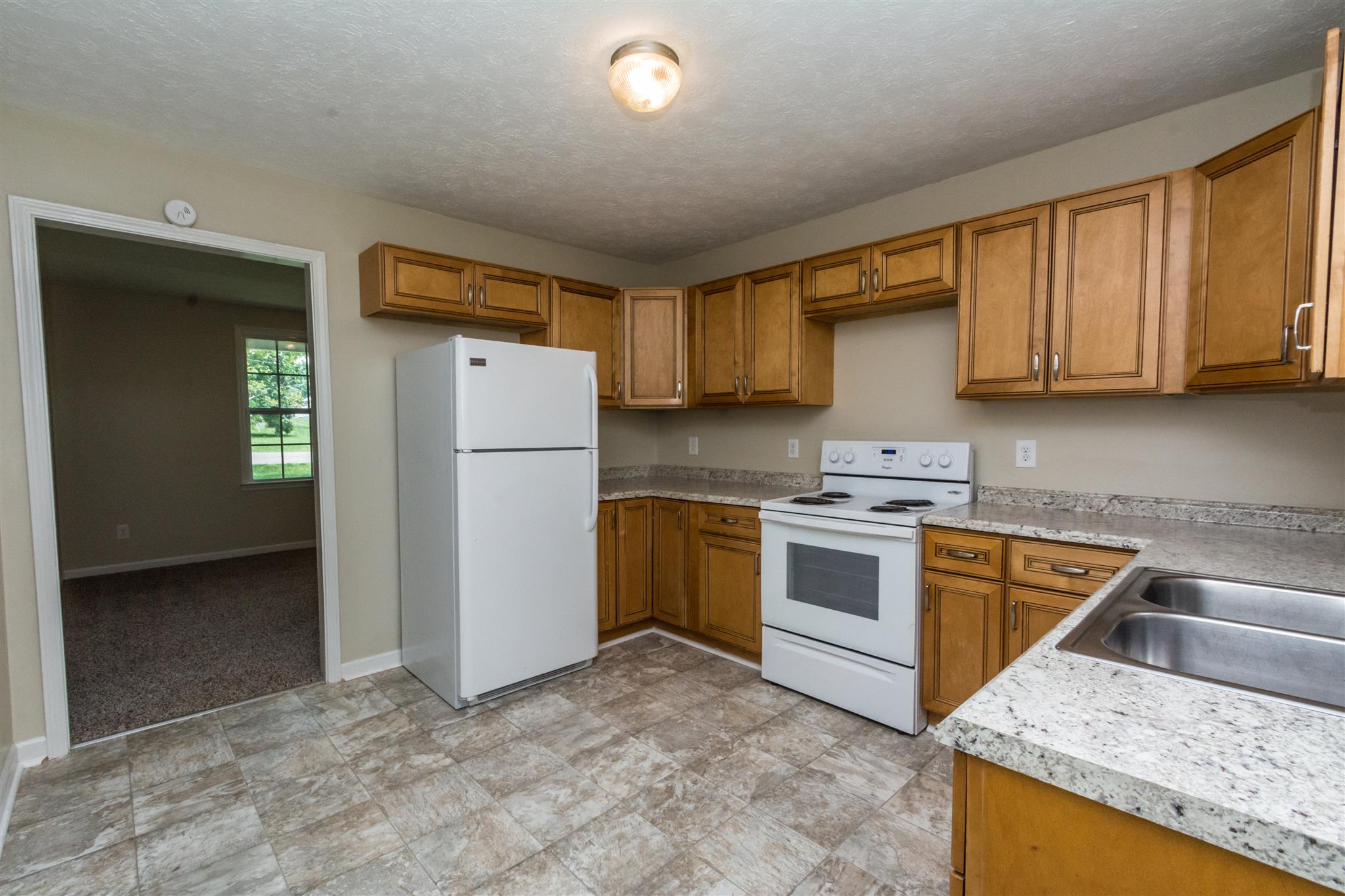 318 Burch Road Clarksville, TN 37042 - Photo 10 of 15 a kitchen with a refrigerator sink and cabinets