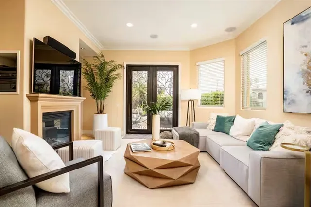 a living room with furniture large window and a fireplace