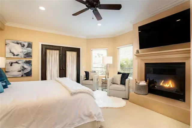 a bedroom with a large bed and a fireplace