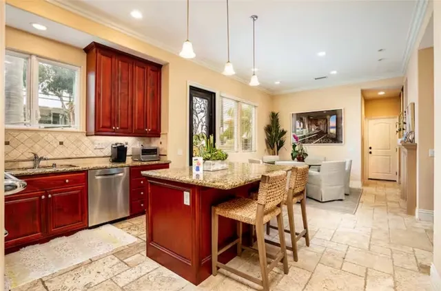 a kitchen with a sink cabinets and window