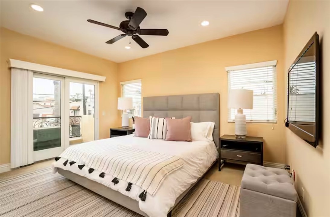 301 16th Street Huntington Beach, CA 92648 - Photo 3 of 16 a bedroom with a large bed and a flat tv screen