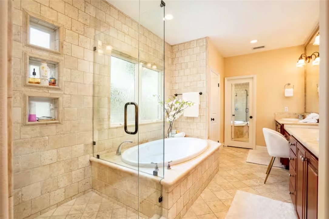 301 16th Street Huntington Beach, CA 92648 - Photo 6 of 16 a spacious bathroom with a tub shower and mirror