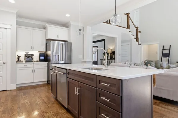 a kitchen with a sink stainless steel appliances and cabinets