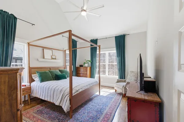 a bedroom with a bed window and flat screen tv