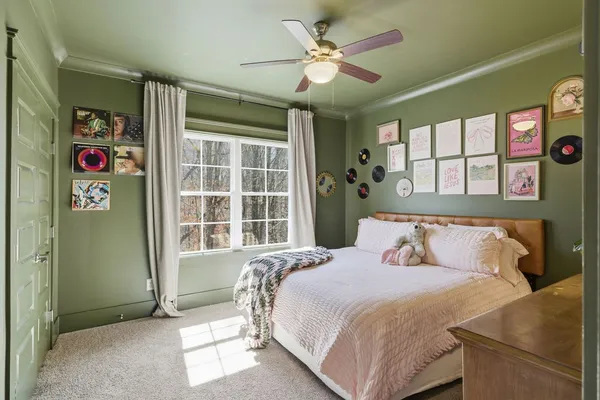 a bedroom with a bed dresser and a window