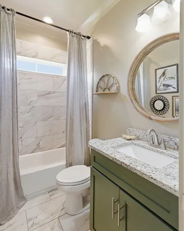 a bathroom with a granite countertop sink toilet mirror and shower