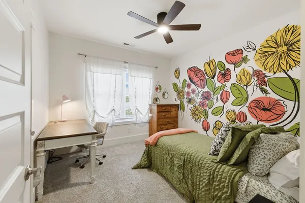 a bedroom with a bed and ceiling fan