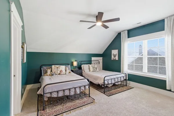 a bedroom with furniture and a large window