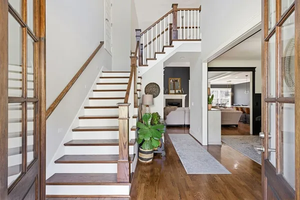 a view of entryway and hall with wooden floor