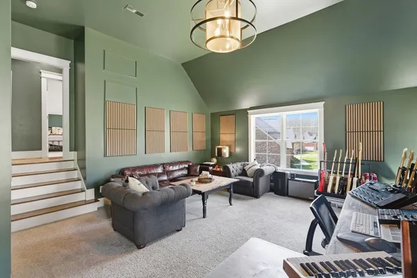 a living room with furniture wooden floor and a window
