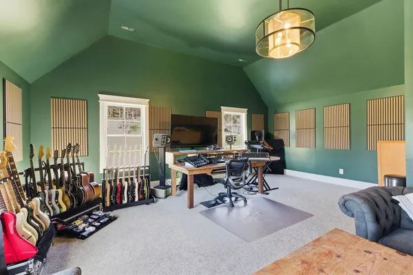 a view of a livingroom with furniture and a large window