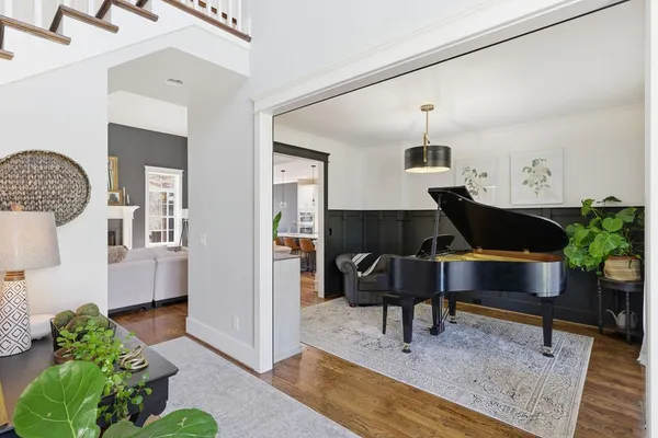 a living room with furniture and wooden floor