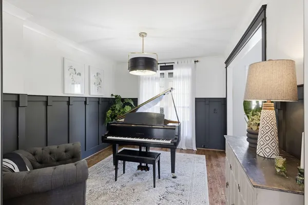 a living room with furniture and a chandelier