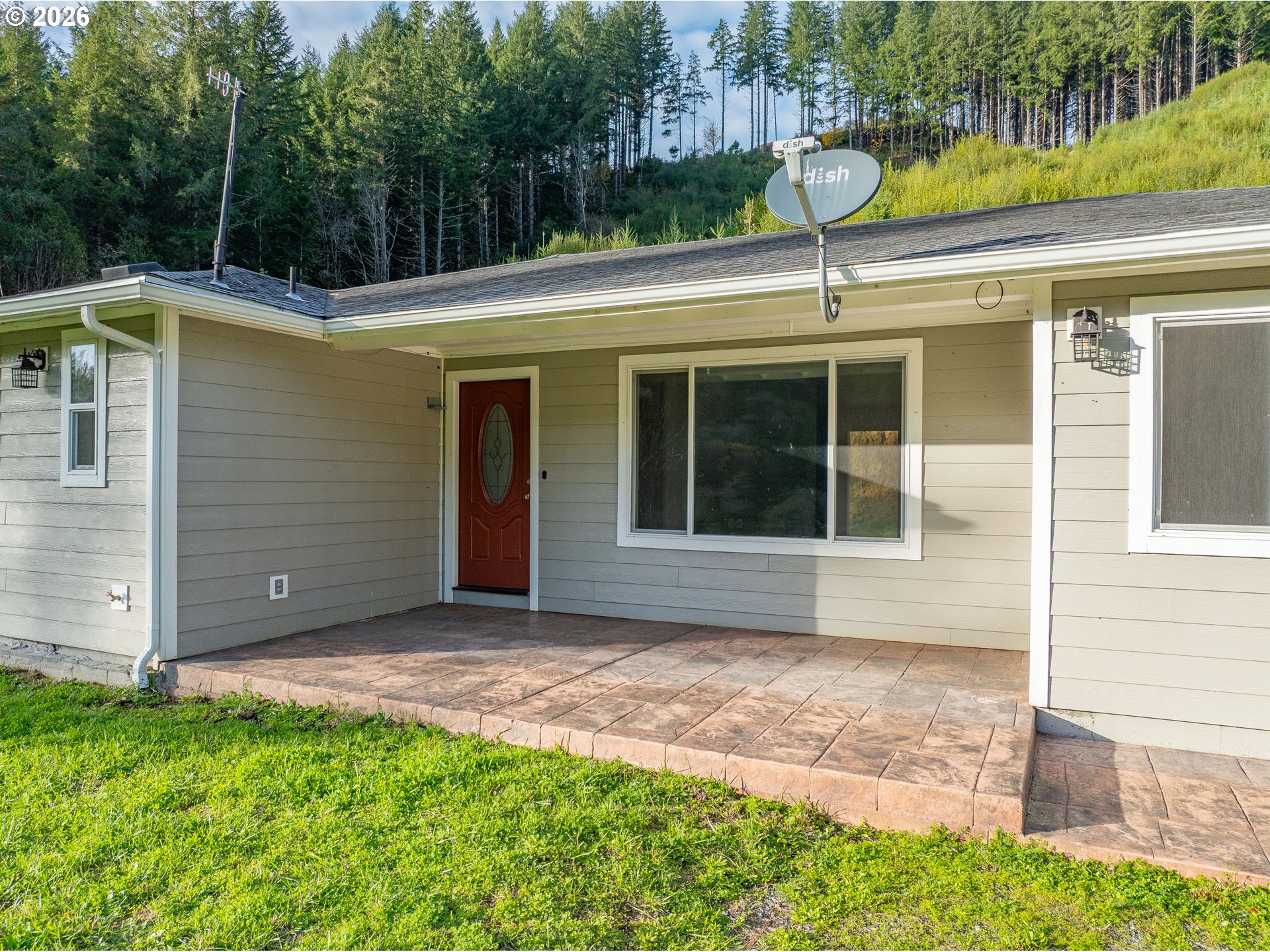 16855 Highway 42 Myrtle Point, OR 97458 - Photo 5 of 43 a view of a house with a backyard and a window