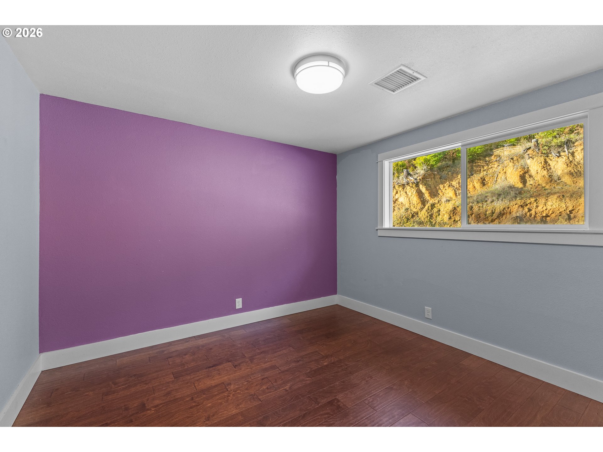 16855 Highway 42 Myrtle Point, OR 97458 - Photo 10 of 43 a view of empty room with wooden floor and fan