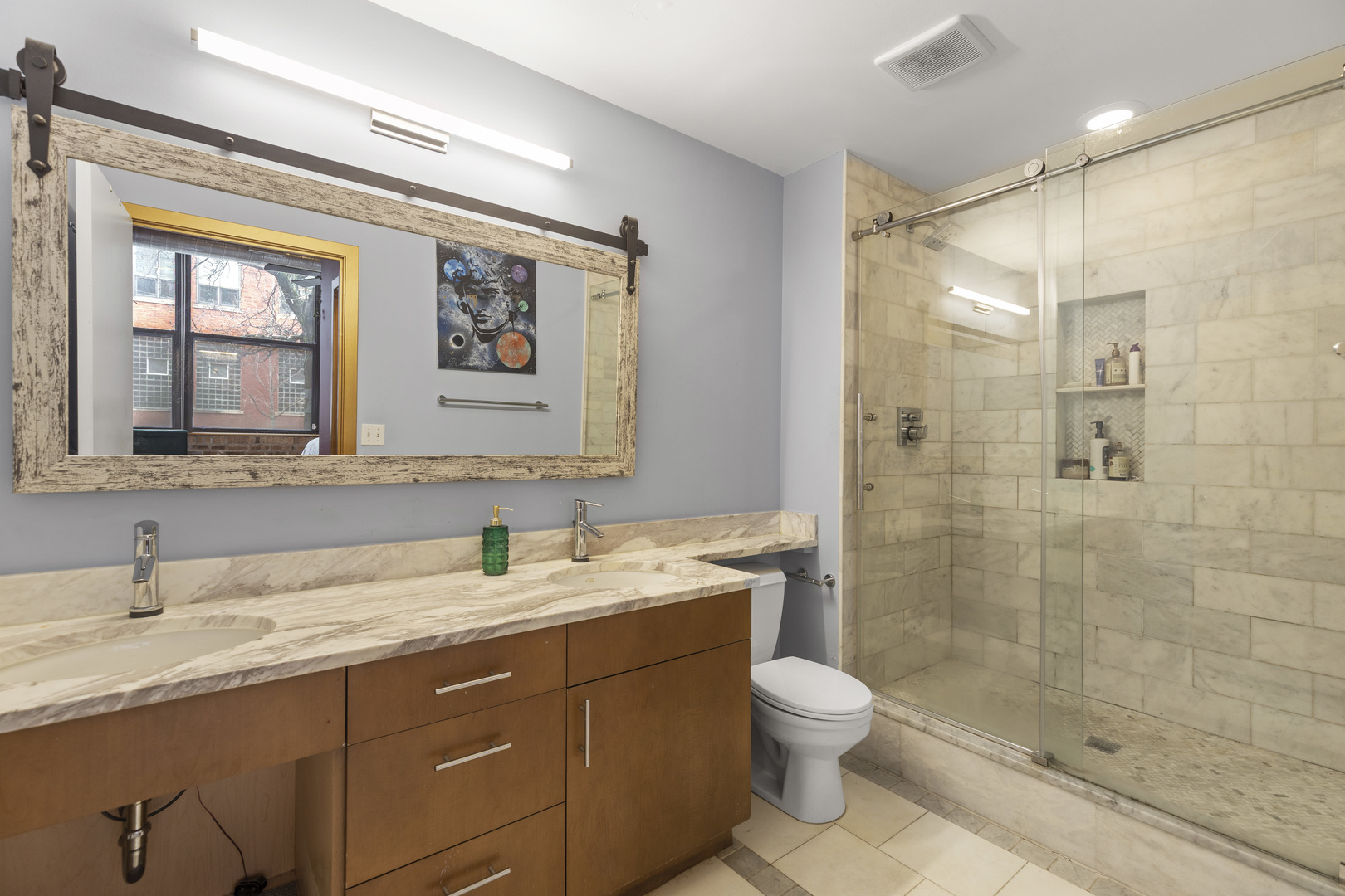1040 West Adams Street, Unit 105 Chicago, IL 60607 - Photo 13 of 18 a bathroom with a granite countertop sink toilet and shower