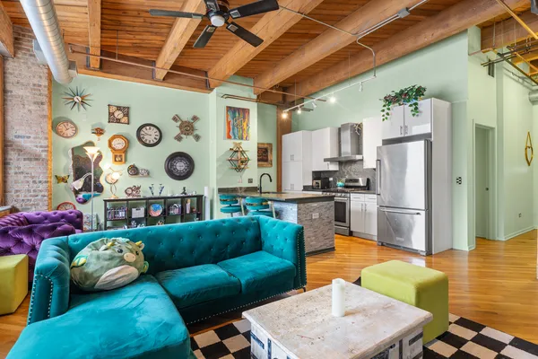 a living room with furniture and kitchen view