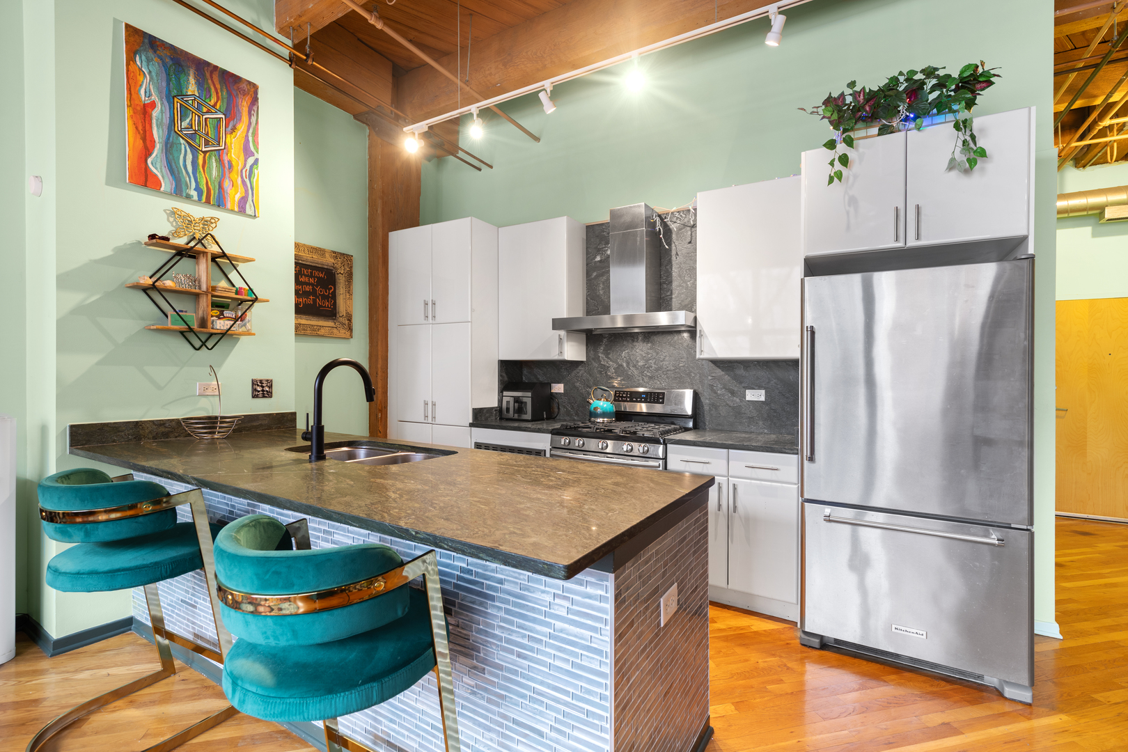 1040 West Adams Street, Unit 105 Chicago, IL 60607 - Photo 7 of 18 a kitchen with stainless steel appliances granite countertop a sink a refrigerator and a stove