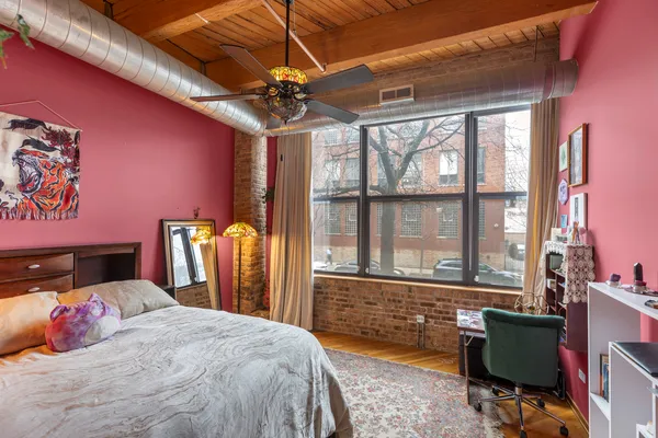 a bedroom with a bed and a chandelier