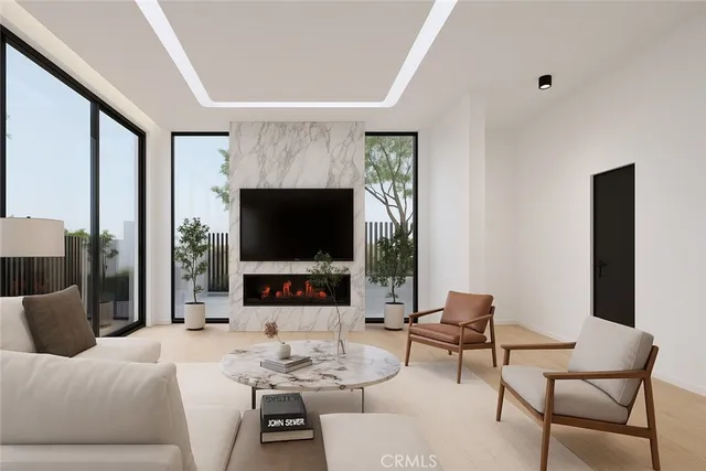 a living room with furniture a flat screen tv and a large window