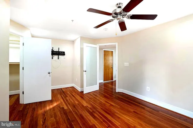 a view of empty room with wooden floor
