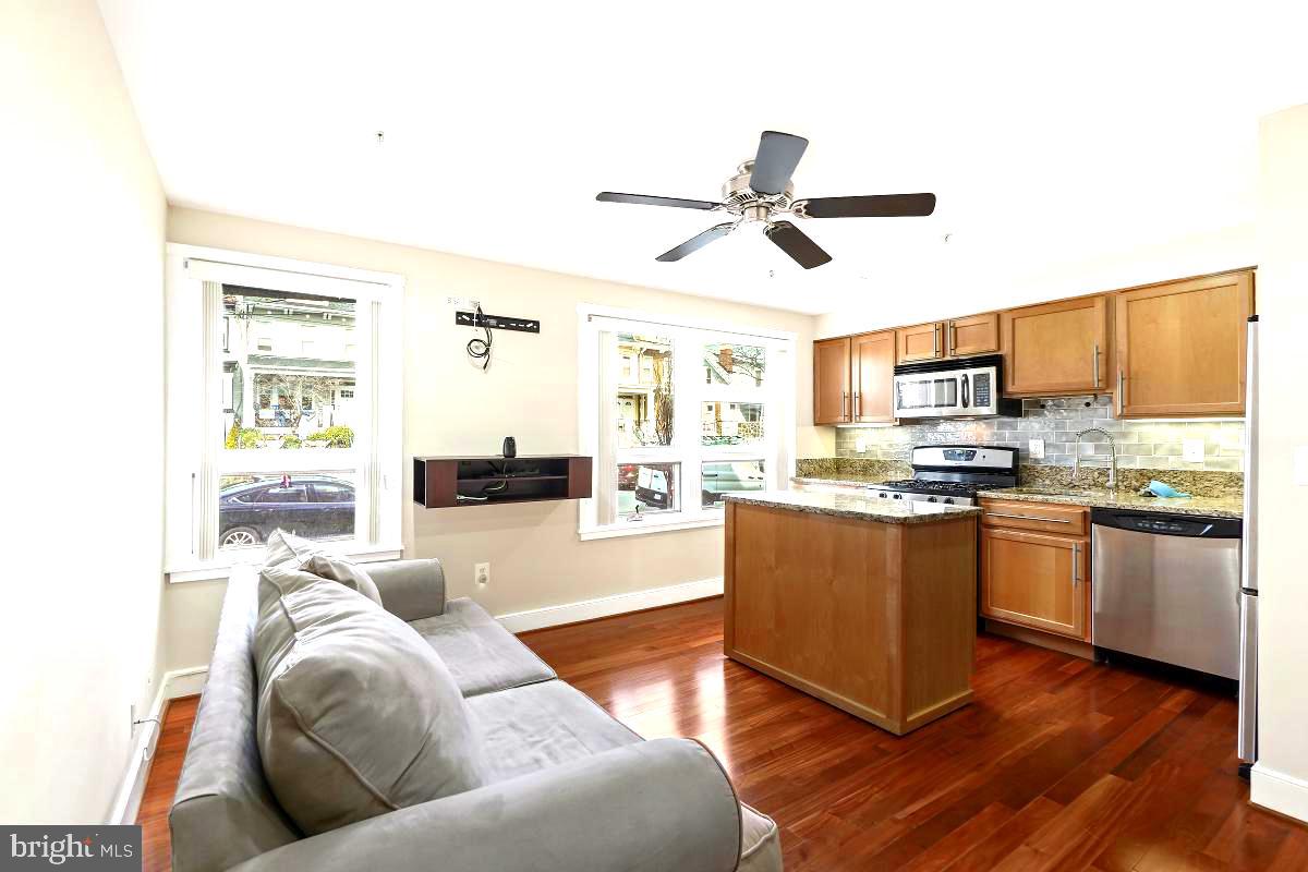 610 Jefferson Street Northwest, Unit 101 Washington, DC 20011 - Photo 10 of 24 a living room with stainless steel appliances granite countertop furniture and a kitchen view