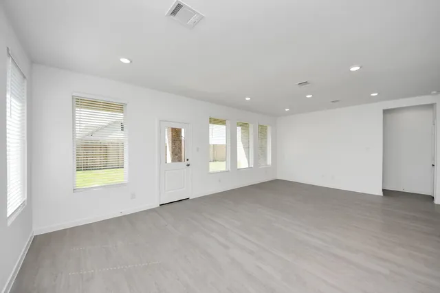 a large white kitchen with stainless steel appliances kitchen island a sink a stove and a refrigerator