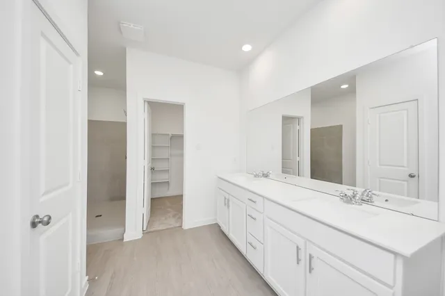 a spacious bathroom with a sink and a mirror