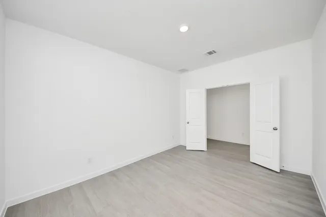 a view of a kitchen with a sink and dishwasher with wooden floor