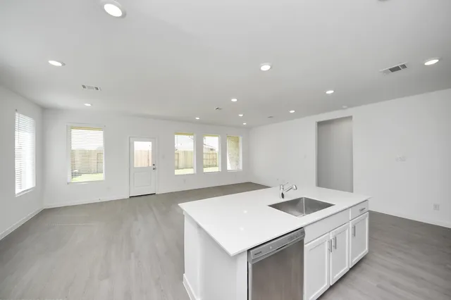 a kitchen with stainless steel appliances granite countertop a sink and a stove