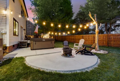 a view of a swimming pool with sitting area and fire pit