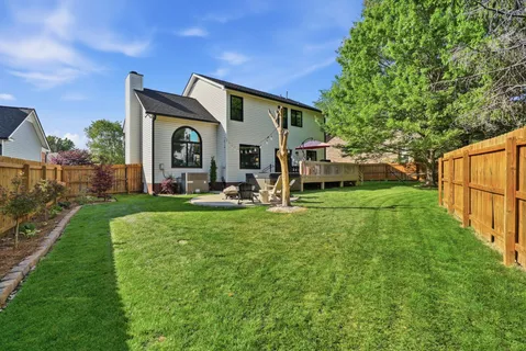 a front view of a house with garden and sitting area
