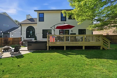 a view of a house with backyard and sitting area