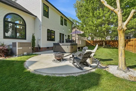 a view of a patio with a dining table and chairs with wooden floor