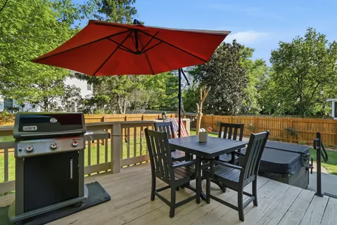 a view of a chairs and table on the roof deck