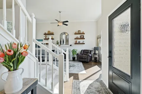 a view of a hallway with a livingroom with furniture