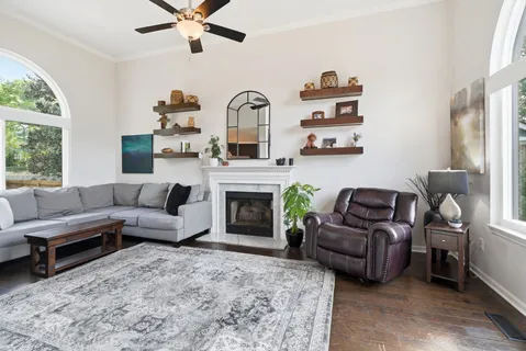 a living room with furniture fireplace and window