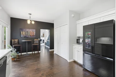 a kitchen with granite countertop white cabinets and stainless steel appliances